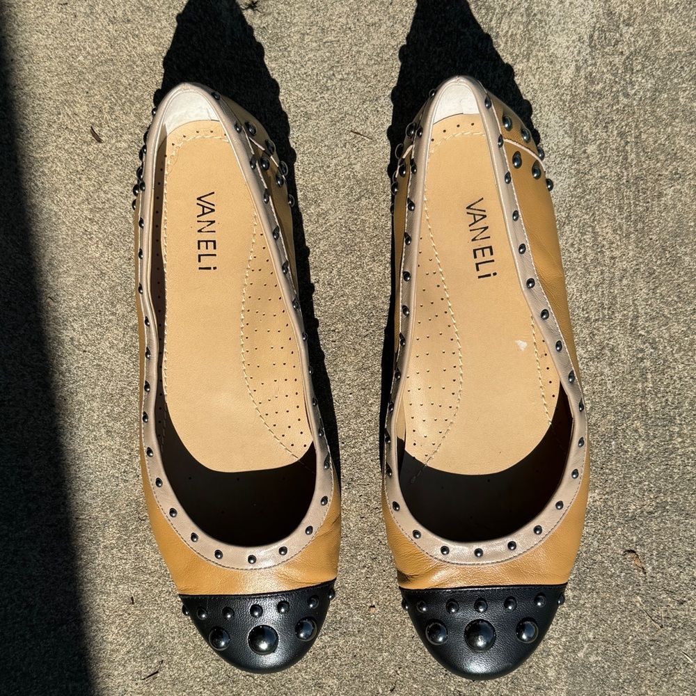 Vaneli black and tan leather cap toe flats with metal stud accents